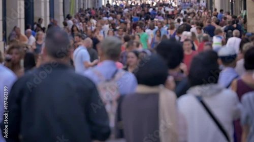 Crowd walking in a large street. Slow motion footage of anonymous people walking photo