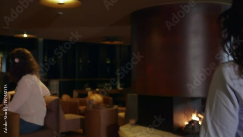 Woman entering in a bar. Steady cam shot, following a woman