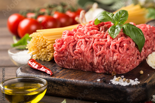 Healthy food background with ingredients for spaghetti Bolognaise or Bolognese with savory minced beef and tomato, basil and spices.