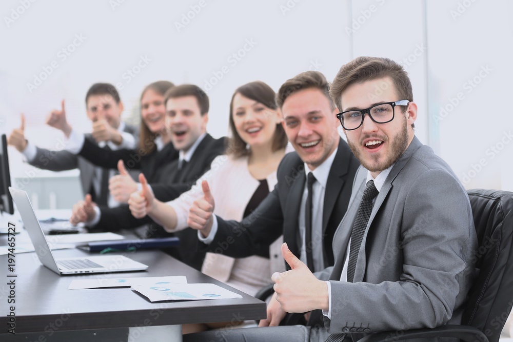 business team with thumbs up while sitting at his Desk business team with thumbs up while sitting at his Desk