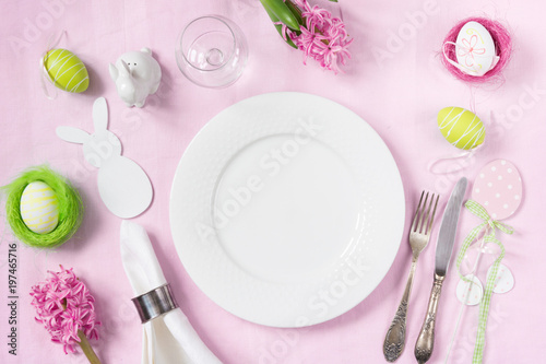 Easter romantic dinner. Elegance table setting spring pink flowers on pink linen tablecloth. Top view.