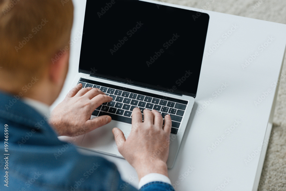 Close-up view of laptop with empty screen in male hands