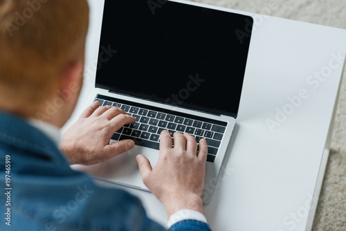 Close-up view of laptop with empty screen in male hands