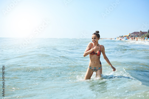happy smiling woman is swimming in the sea