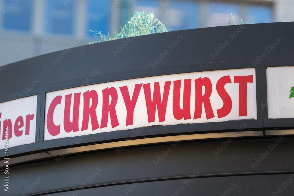 Currywurst restaurant signage. Currywurst is a fast food dish of German origin consisting of pork sausage seasoned with curry ketchup Currywurst restaurant signage. Currywurst is a fast food dish of German origin consisting of pork sausage seasoned with curry ketchup