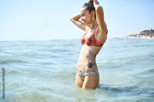 happy smiling woman is swimming in the sea