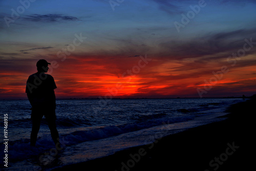 Sunset over lake or sea and the silhouette of man © 4F.MEDIA