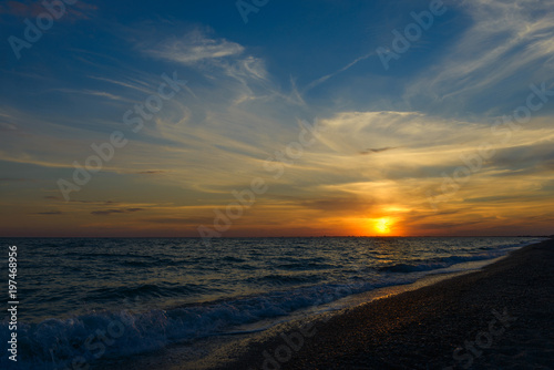 Beautiful sunset above the sea with waves © 4F.MEDIA