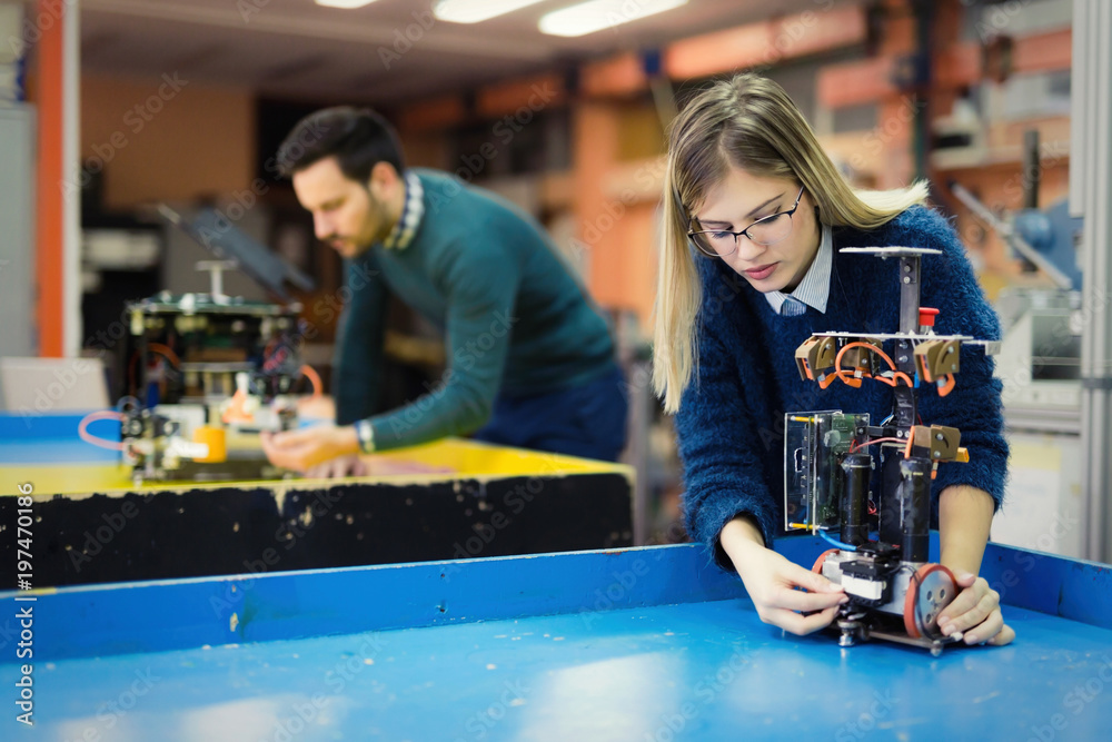 Fotografie Young woman engineer working on robotics project