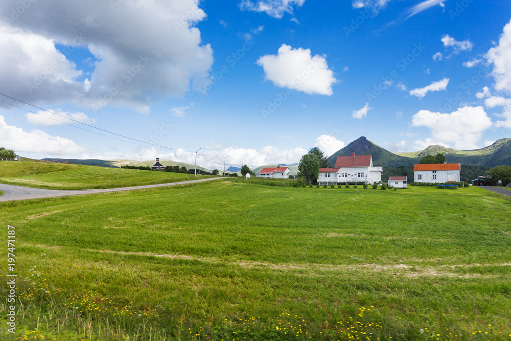 Typical scandinavian landscape with meadows, mountains and village. Lofoten islands, Norway. Typical scandinavian landscape with meadows, mountains and village. Lofoten islands, Norway.