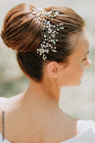 stylish woman in white dress and hair accessories