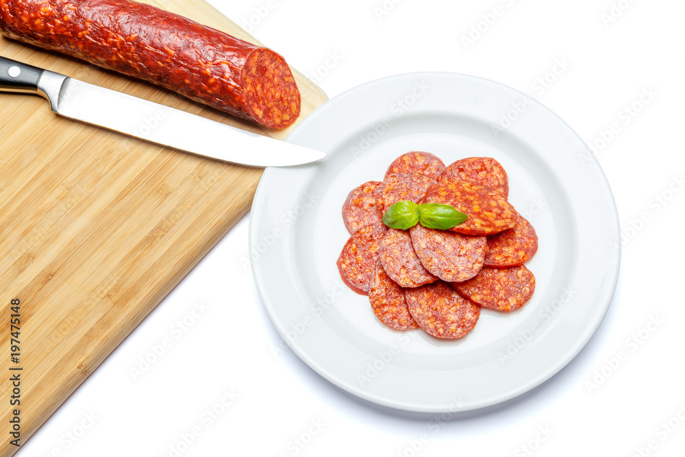 Italian Salami or spanish chorizo on plate white background Italian Salami or spanish chorizo on plate white background