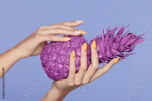 Nails Manicure. Hand With Stylish Nails Holding Purple Pineapple