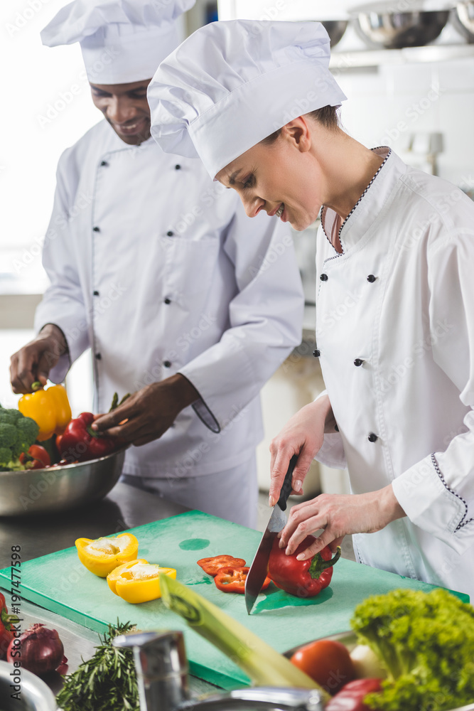 chef cutting bell peppers at restaurant kitchen chef cutting bell peppers at restaurant kitchen