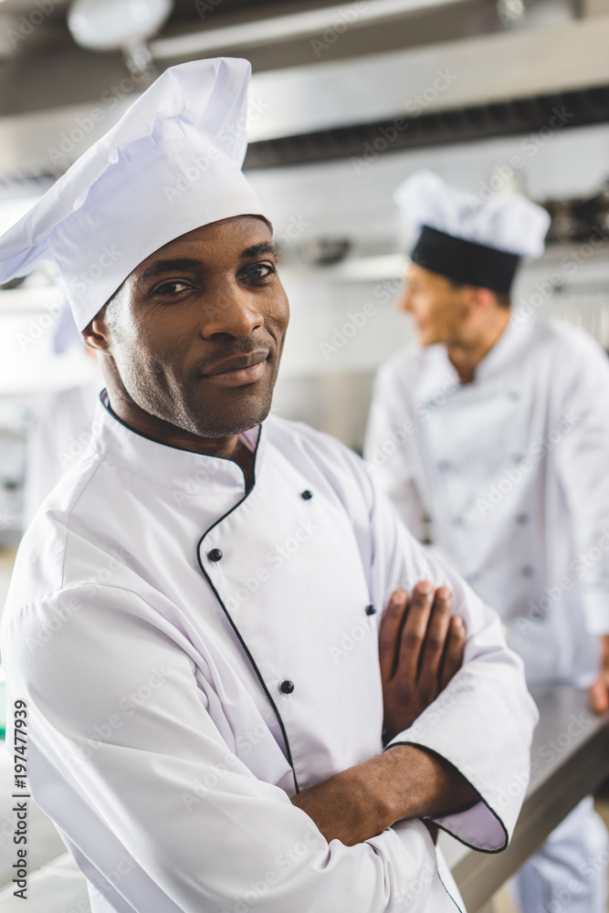 handsome african american chef looking at camera with crossed arms