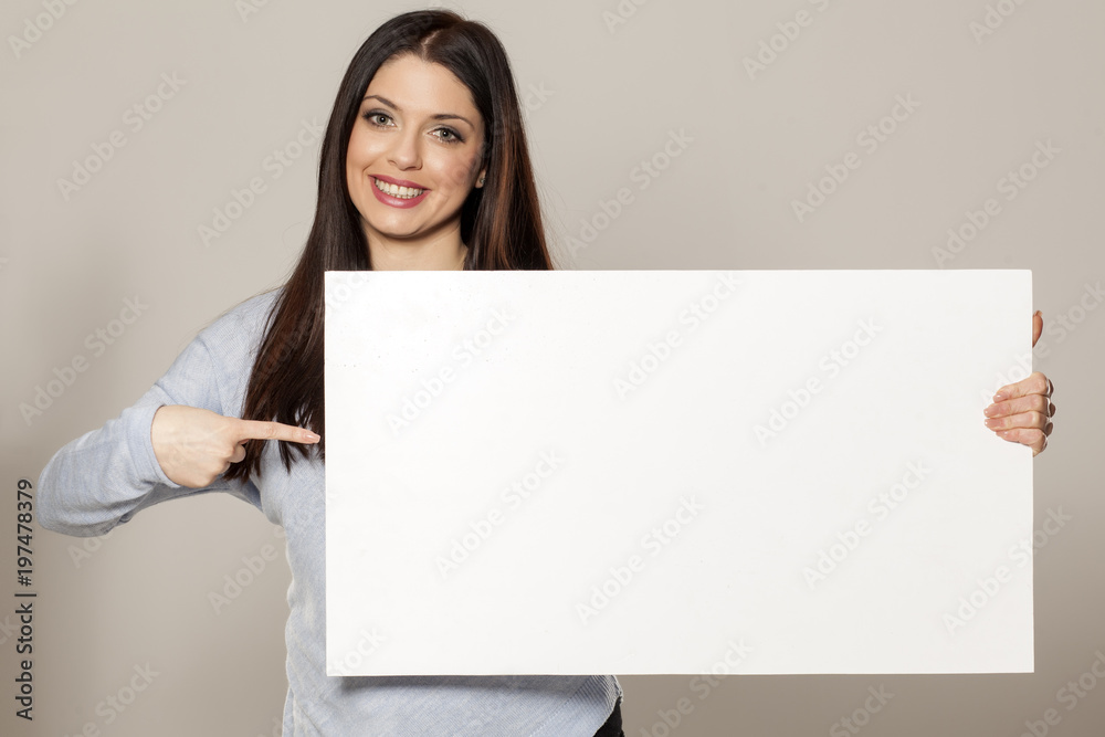 Happy woman showing empty blank paper card sign with copy space for text Happy woman showing empty blank paper card sign with copy space for text