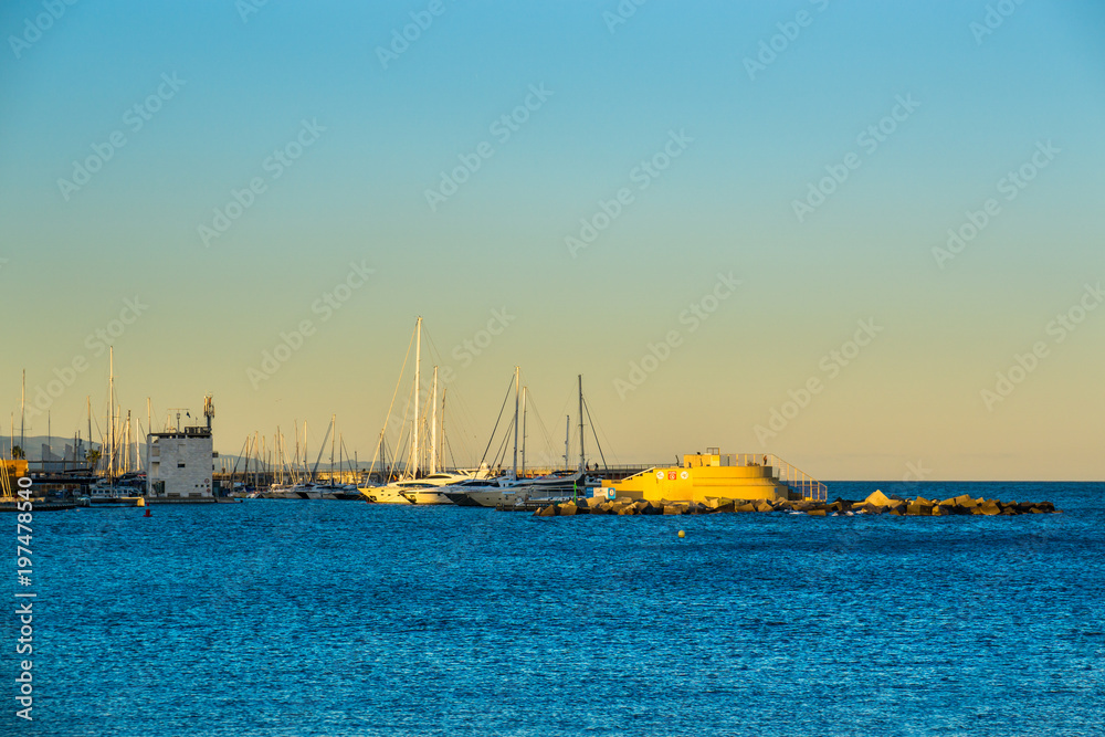 Boats and ships on the sea in front of sunset