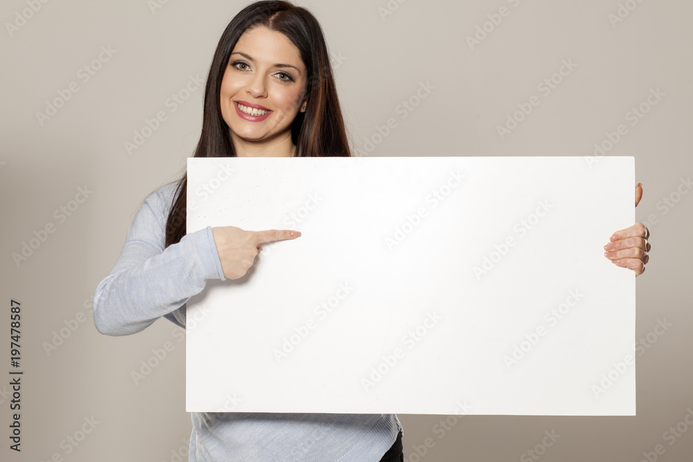 Happy woman showing empty blank paper card sign with copy space for text Happy woman showing empty blank paper card sign with copy space for text