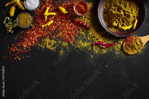 Fototapeta Naklejka Na Ścianę i Meble -  Exotically Spice Mix - spice, herbs, powder top view over dark background. Cooking and spicy food concept. Copy space