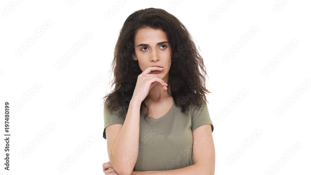 Portrait of concentrated brunette woman touching chin thinking about important things and doubting or trying to calculate best option, over white background. Concept of emotions Portrait of concentrated brunette woman touching chin thinking about important things and doubting or trying to calculate best option, over white background. Concept of emotions
