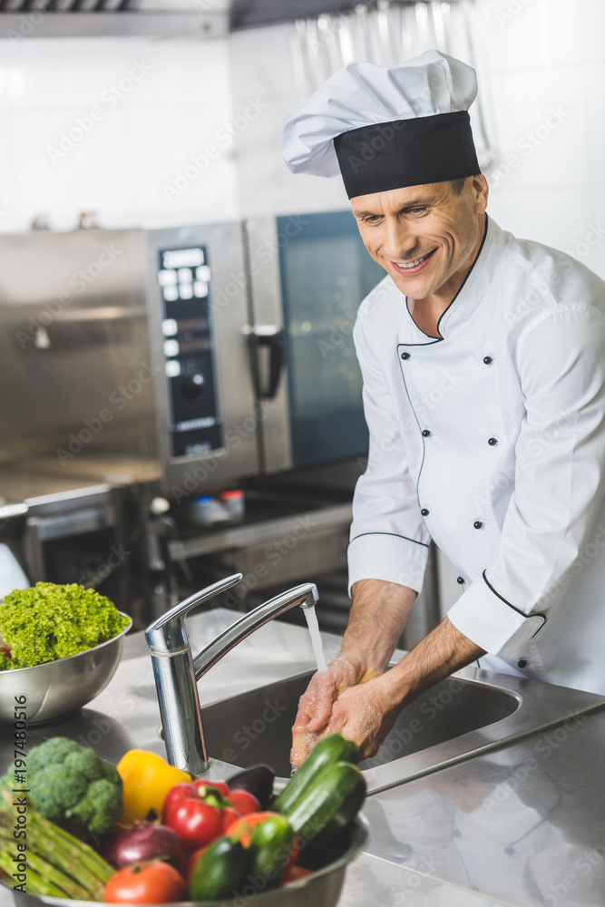 handsome chef washing hands at restaurant kitchen handsome chef washing hands at restaurant kitchen