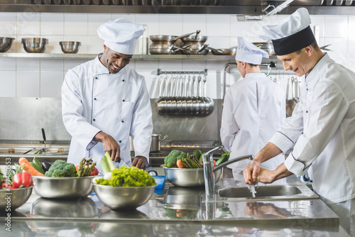 multicultural chefs cooking at restaurant kitchen