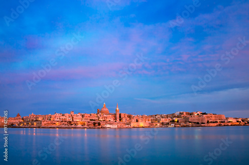 Valletta Skyline at beautiful sunset from Sliema with churches of Our Lady of Mount Carmel and St. Paul's Anglican Pro-Cathedral, Valletta, Capital city of Malta