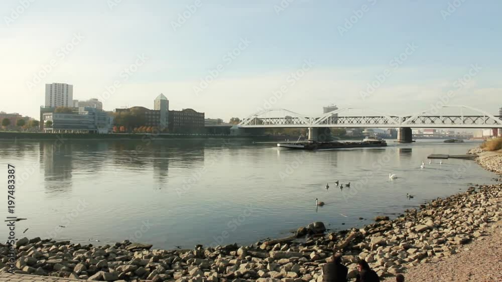 a typical ship on the rhein river is passing Ludwigshafen and Mannheim during a wonderful autumn atmosphere