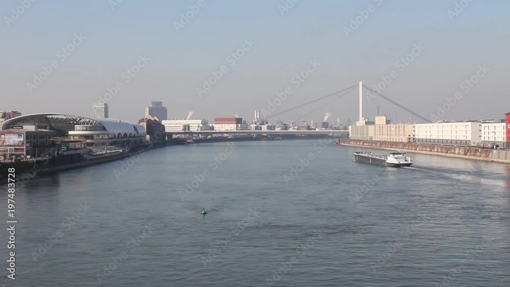 a typical ship on the rhein river is passing Ludwigshafen and Mannheim during a wonderful autumn atmosphere