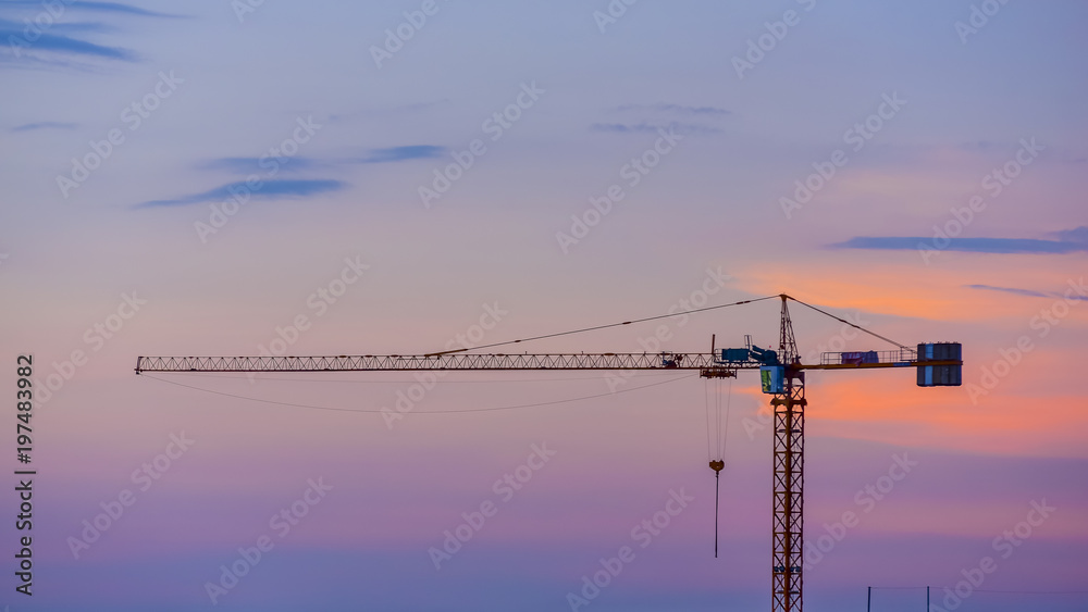 The Construction crane of building on sunset time with twilight sky background The Construction crane of building on sunset time with twilight sky background