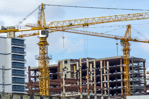 two yellow building cranes at work