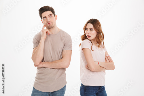 Photo of adult naughty woman wearing beige t-shirts acting like offended girl and not speaking to her boyfriend, over white background
