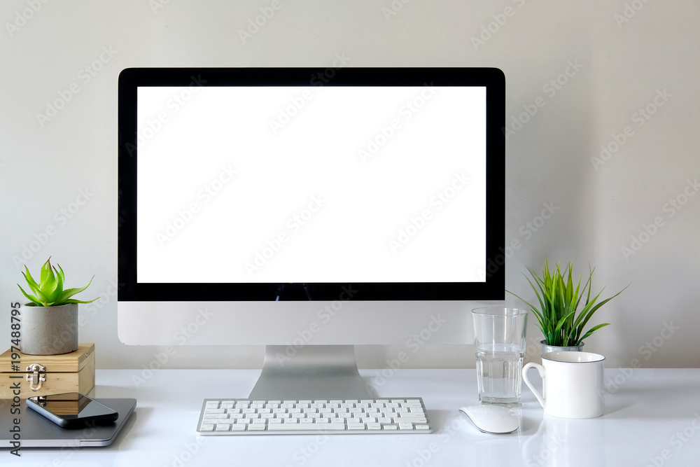 Workspace with computer with blank white screen Workspace with computer with blank white screen