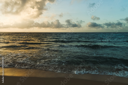 colorful light of sunset reflecting on the waves at the beach of baltic sea