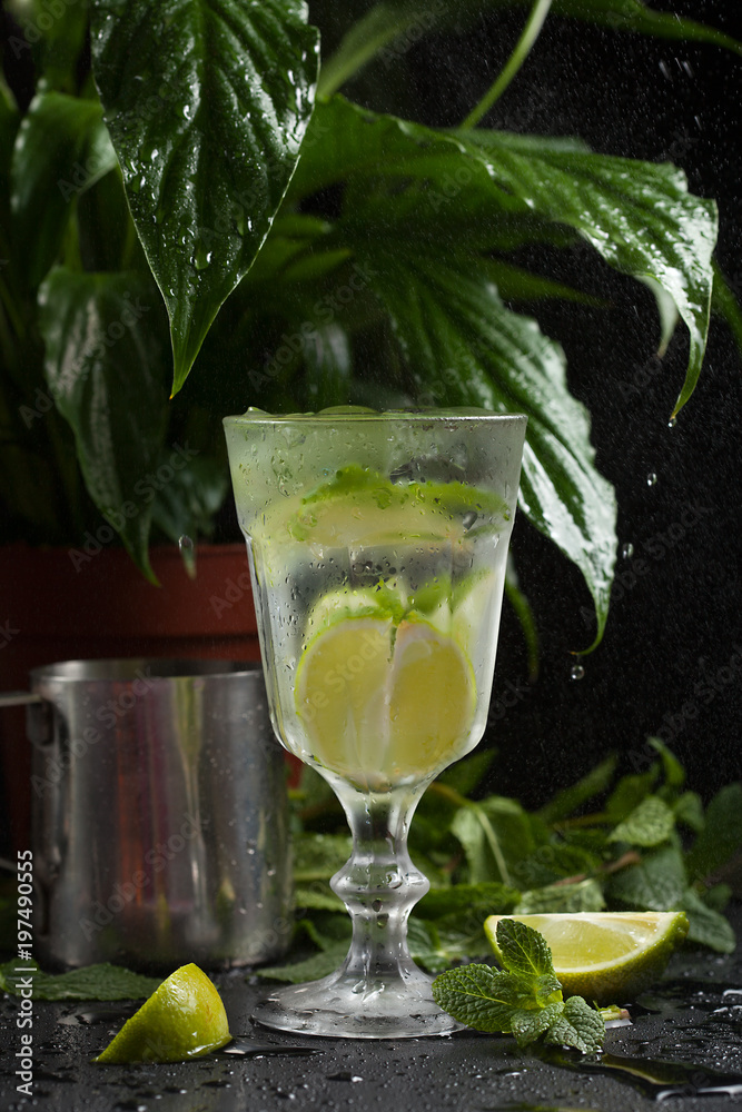 Fototapeta premium lemonade in a glass on a dark background. spray and motion