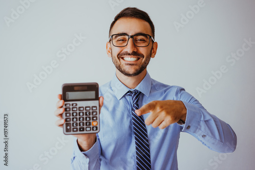 Smiling Business Man Showing Calculator photo