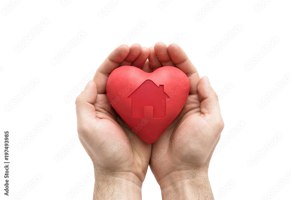 Fototapeta premium Red heart with imprinted house shape in man's hands.