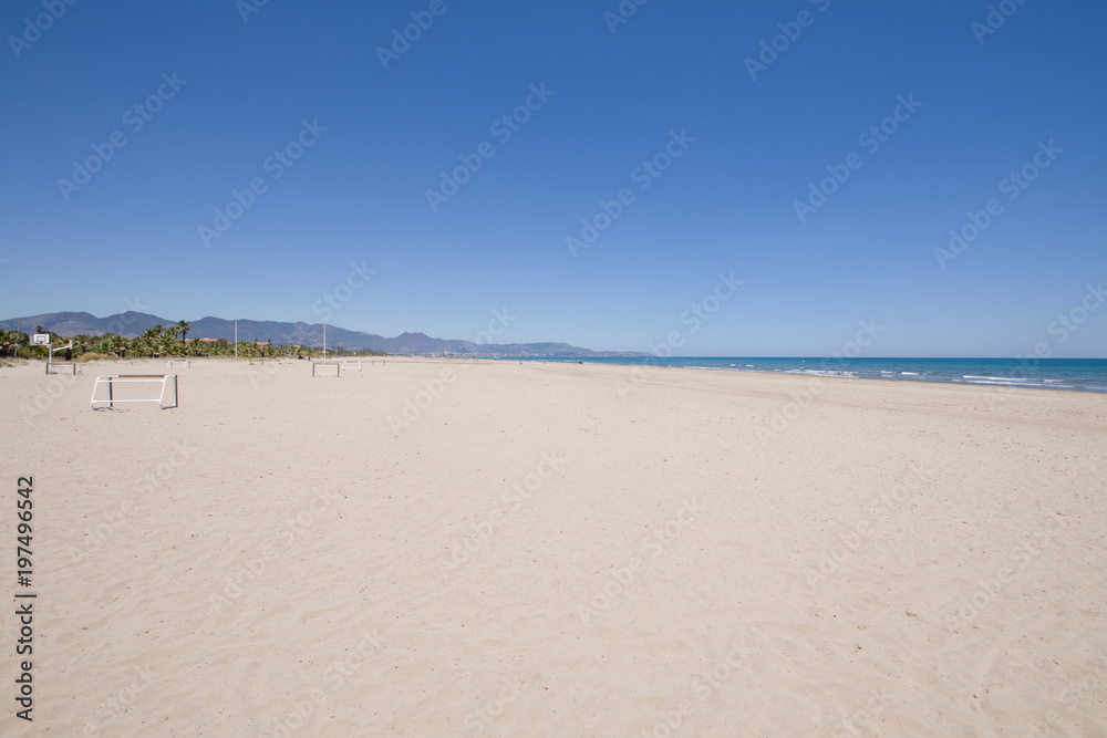 landscape Beach of PIne or Pinar, in Grao of Castellon, Valencia, Spain, Europe. Blue clear sky, Mediterranean Sea and Benicassim in the horizon
