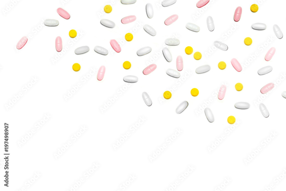 a lot of multicolored pills and tablets on the white background with copy space for text. a lot of multicolored pills and tablets on the white background with copy space for text.