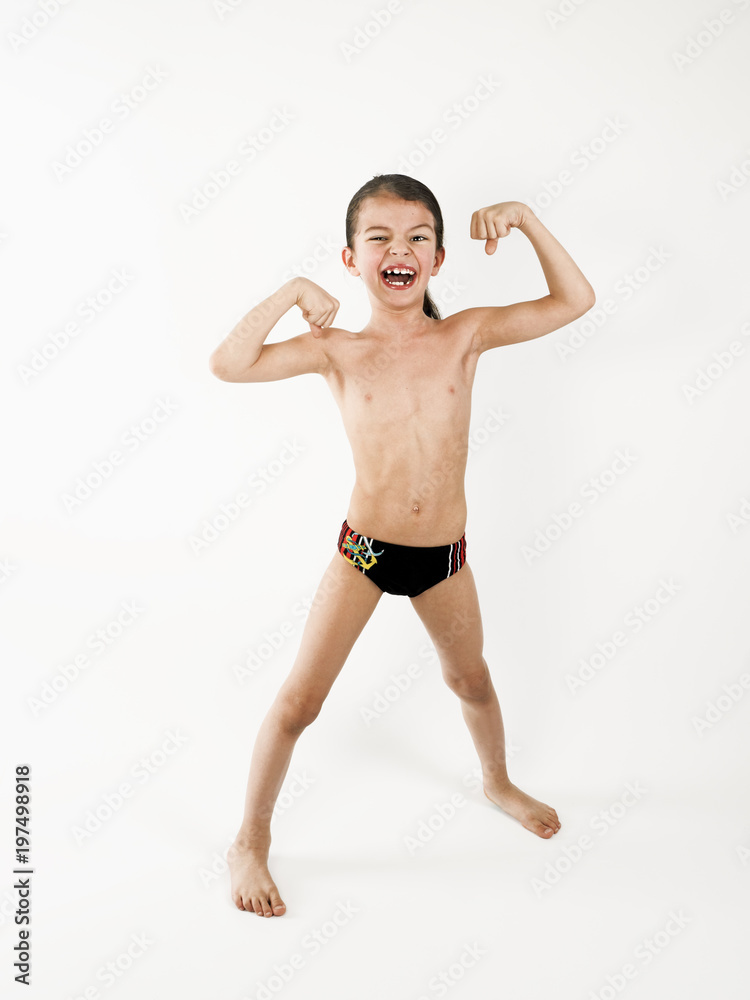 Happy little boy triumphing with raised hands, on a light background