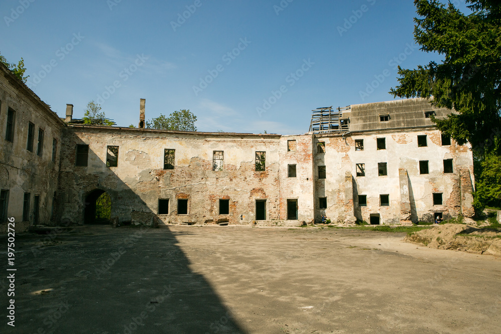 Ruins of the old Klevan castle. Ruined wall with windows against the blue sky. Courtyard. Rivne region. Ukraine