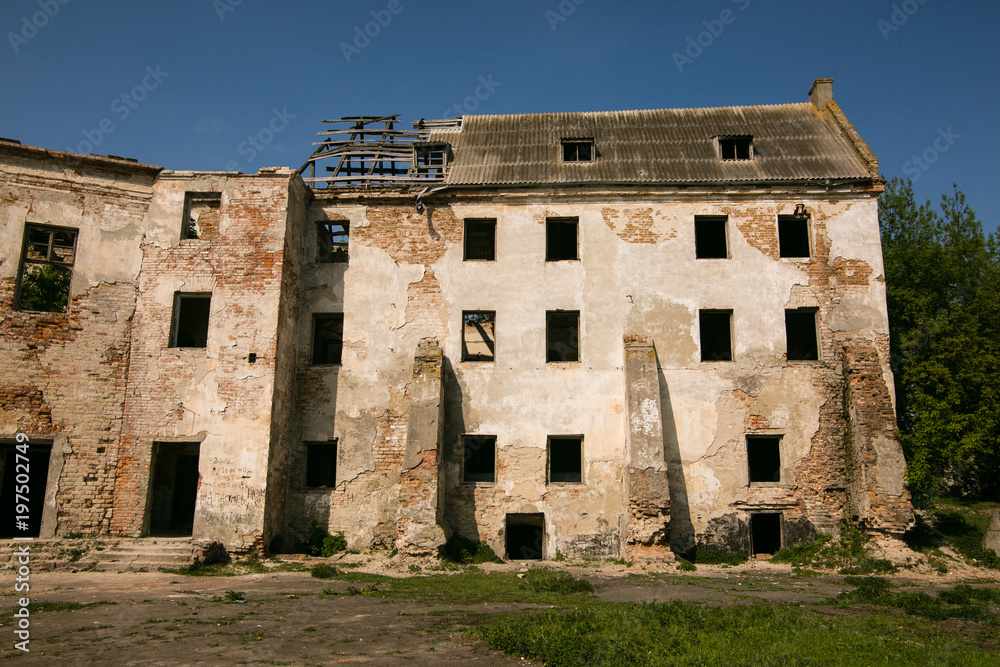 Ruins of the old Klevan castle. Ruined wall with windows against the blue sky. Courtyard. Rivne region. Ukraine