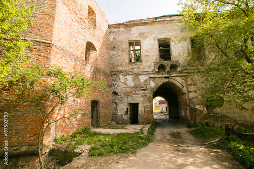 Fototapeta Naklejka Na Ścianę i Meble -  Ruins of the old Klevan castle. Ruined wall with windows against the blue sky. Courtyard. Rivne region. Ukraine