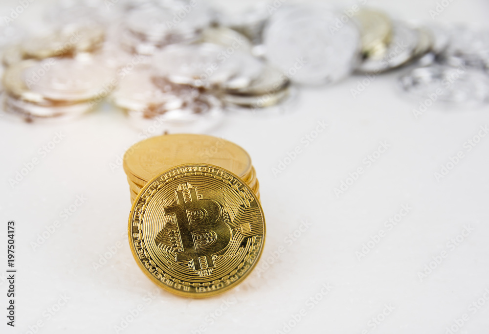 In selective focus of golden bitcoin put on background,in front of blurred silver bitcoin,blurry light design background. In selective focus of golden bitcoin put on background,in front of blurred silver bitcoin,blurry light design background.