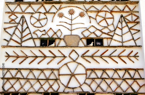 Unique decorative patterns on the exterior wall of a traditional dovecote-style house in Volax village. Tinos island, Cyclades, Greece.