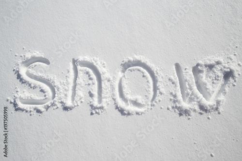 Handwritten inscription on pure white snowdrift - snow.