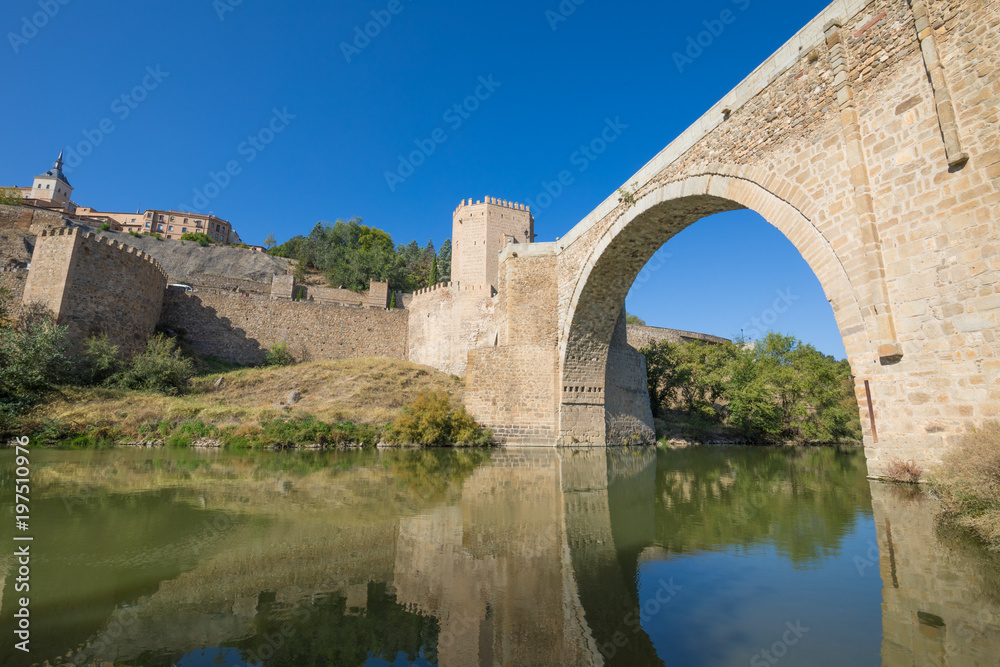 arch of Alcantara bridge, landmark and monument from ancient Roman age, from green water river Tagus, Tajo in Spanish, in Toledo city, Spain, Europe
arch of Alcantara bridge, landmark and monument from ancient Roman age, from green water river Tagus, Tajo in Spanish, in Toledo city, Spain, Europe