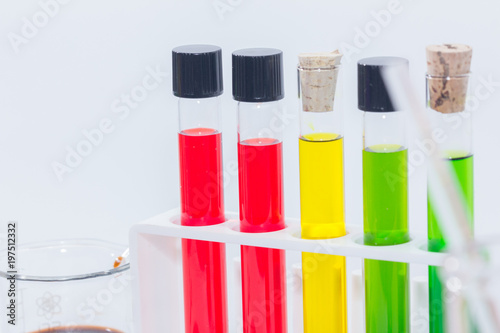 close up of colorful liquid in test tubes on rack