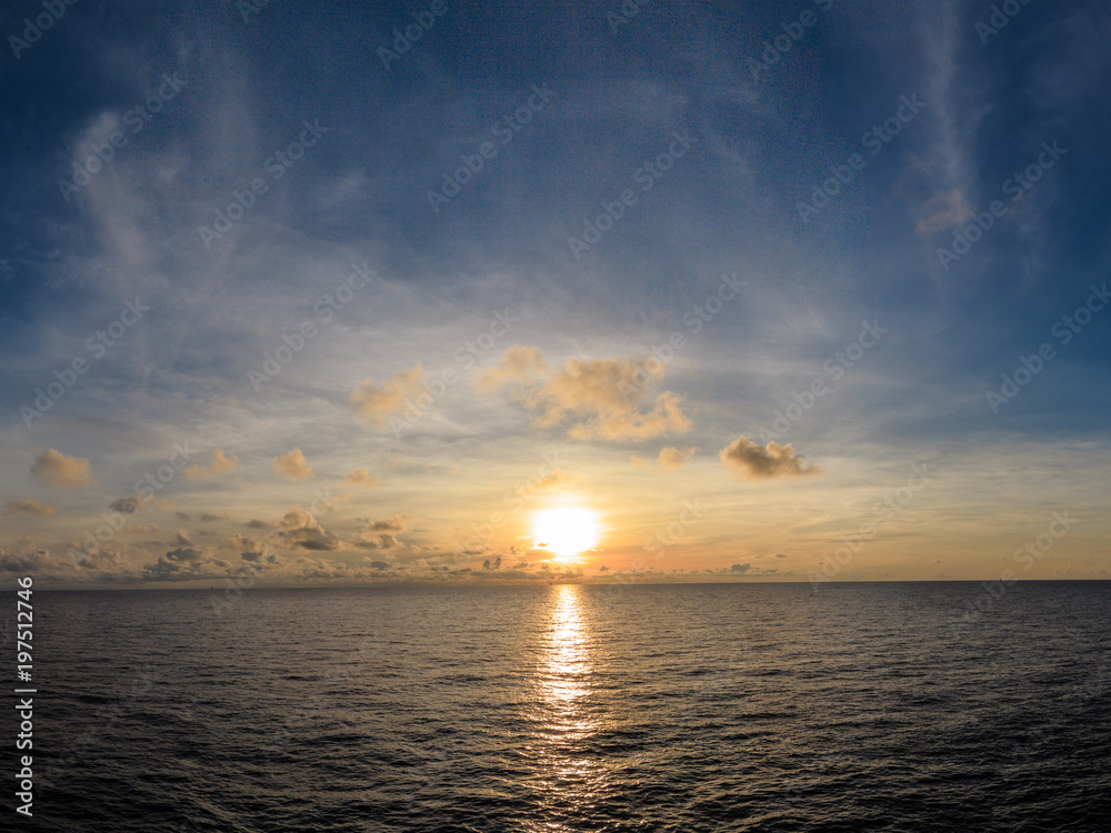 Blue sea and blue sky with white cloud and sunrise up from sea in gulf of Thailand.
