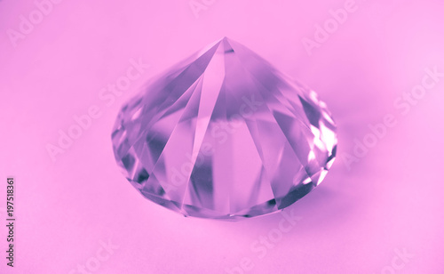 Pink shiny brilliant gemstone crystal. Violet jewelry diamond isolated on a white background. photo